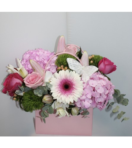 Marivel's Handbag Blooms. An arrangement by Marivel's Florist and Gifts.