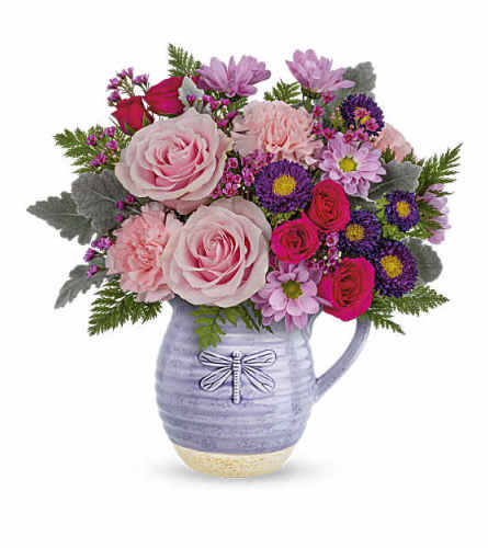 Teleflora's Playful Pitcher. An arrangement by Love Floral.