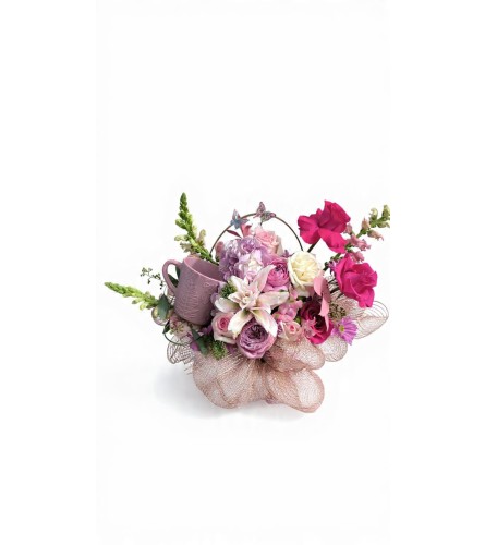 Sweet Petal Delight with a mug. An arrangement by Sunshine Flowers and Events.