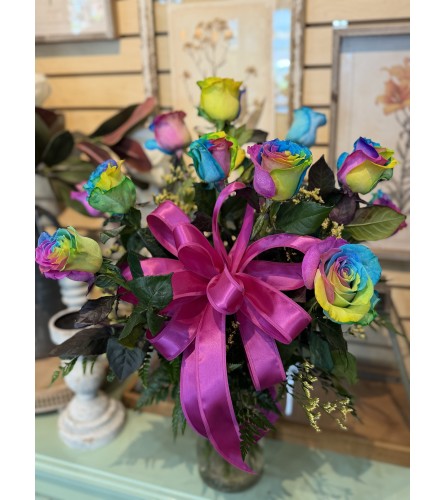 Dozen Rainbow Roses. An arrangement by Busse and Rieck Flowers Plants and Gifts.
