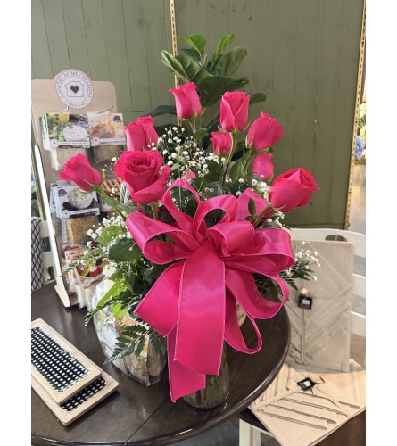 Dozen Hot Pink Roses. An arrangement by Busse and Rieck Flowers Plants and Gifts.