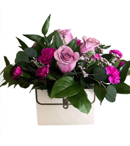 Lavender Garden Satchel. An arrangement by Goodman's Florist.