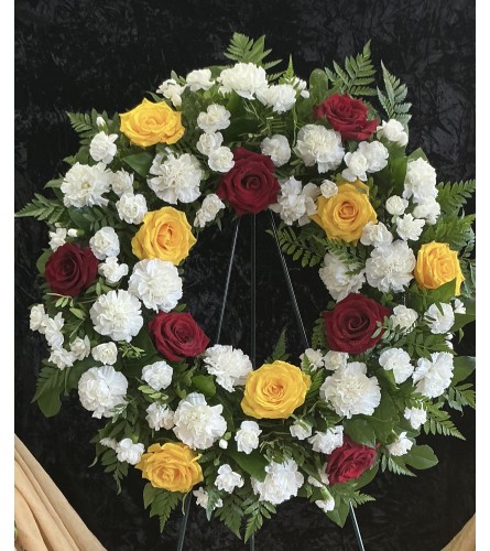 In The Garden Wreath. An arrangement by Roma Flowers and Gifts.