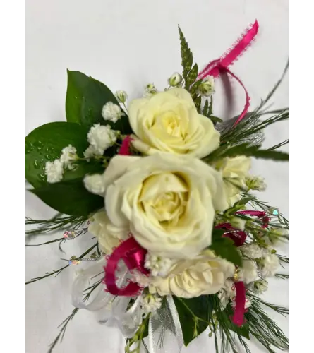 White and Pink Wrist Corsage. An arrangement by April Showers Floral Designs.