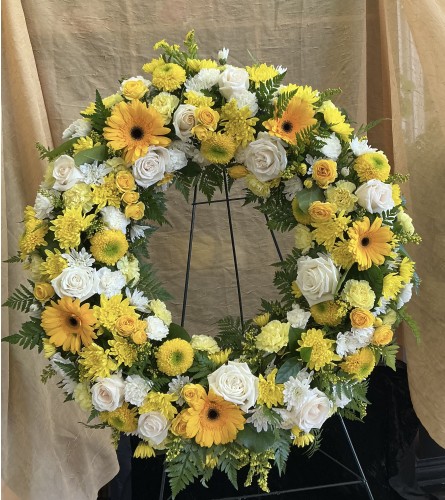 Rest Peacefully Wreath. An arrangement by Roma Flowers and Gifts.