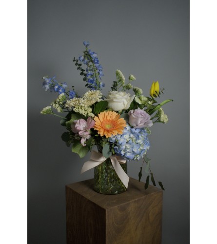 Pastel designer's choice in a diamond vase. An arrangement by Enchanted Florist.