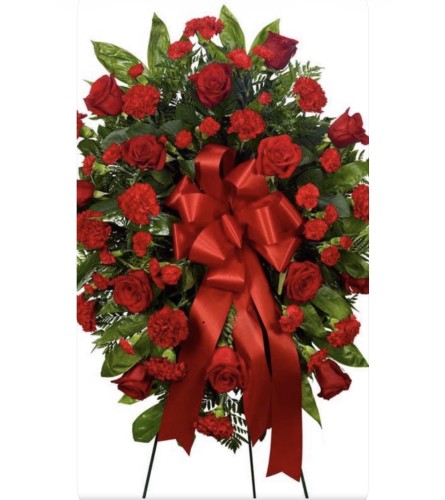 Spray Love in Red. An arrangement by Charming Blooms.