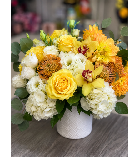 Radiant Warmth Arrangement. An arrangement by Floral Lady Design Studio LLC.