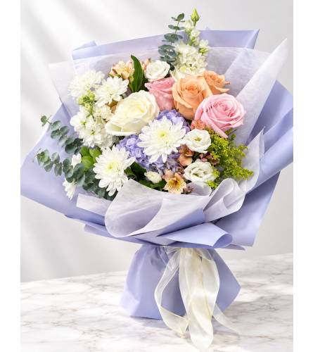Pastel Lavender Wrapped Bouquet. An arrangement by Queens Flowers.