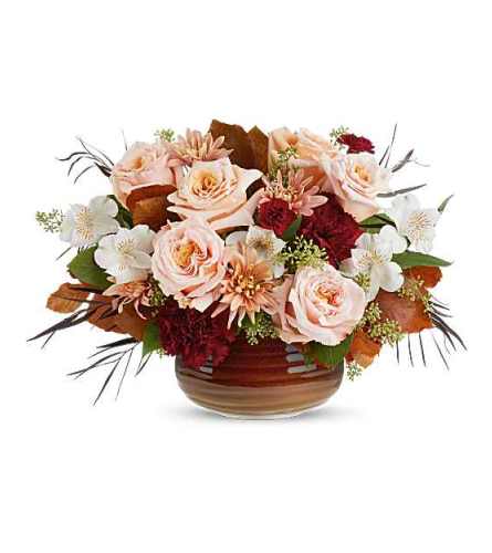 Teleflora's Sunset Stone Centerpiece - Deluxe. An arrangement by Marivel's Florist and Gifts.