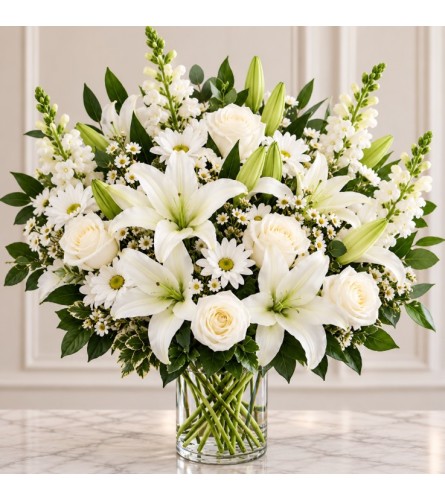 White Soorow - Deluxe. An arrangement by Geni's Florist and Gifts.