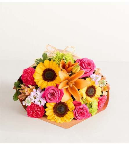The Floral Embrace Wrapped Bouquet - Deluxe. An arrangement by Flowers of Jacksonville.