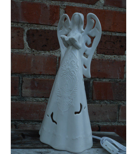 Lighted porcelain angel. An arrangement by Metcalfe Florist and Pleasant View Greenhouses.