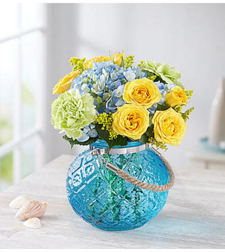 Coastal Garden™ in a Blue Vase - Standard. An arrangement by Susana's Flowers.