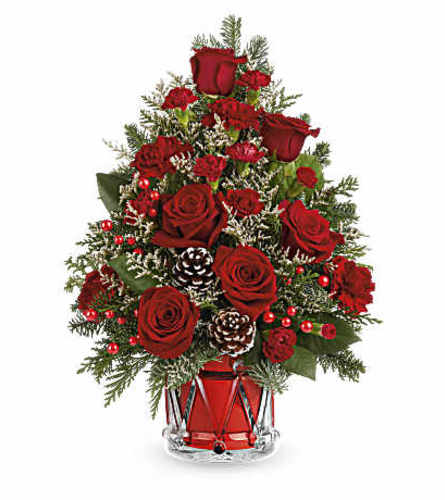 The Teleflora's Yuletide Sparkle Tree - Deluxe. An arrangement by Marivel's Florist and Gifts.