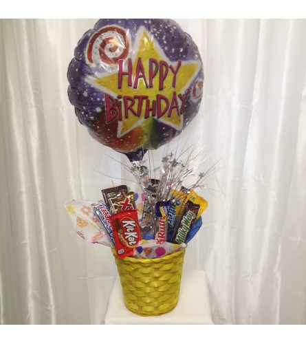 CHOCOLATE CANDY BASKET. An arrangement by The Floral Basket.