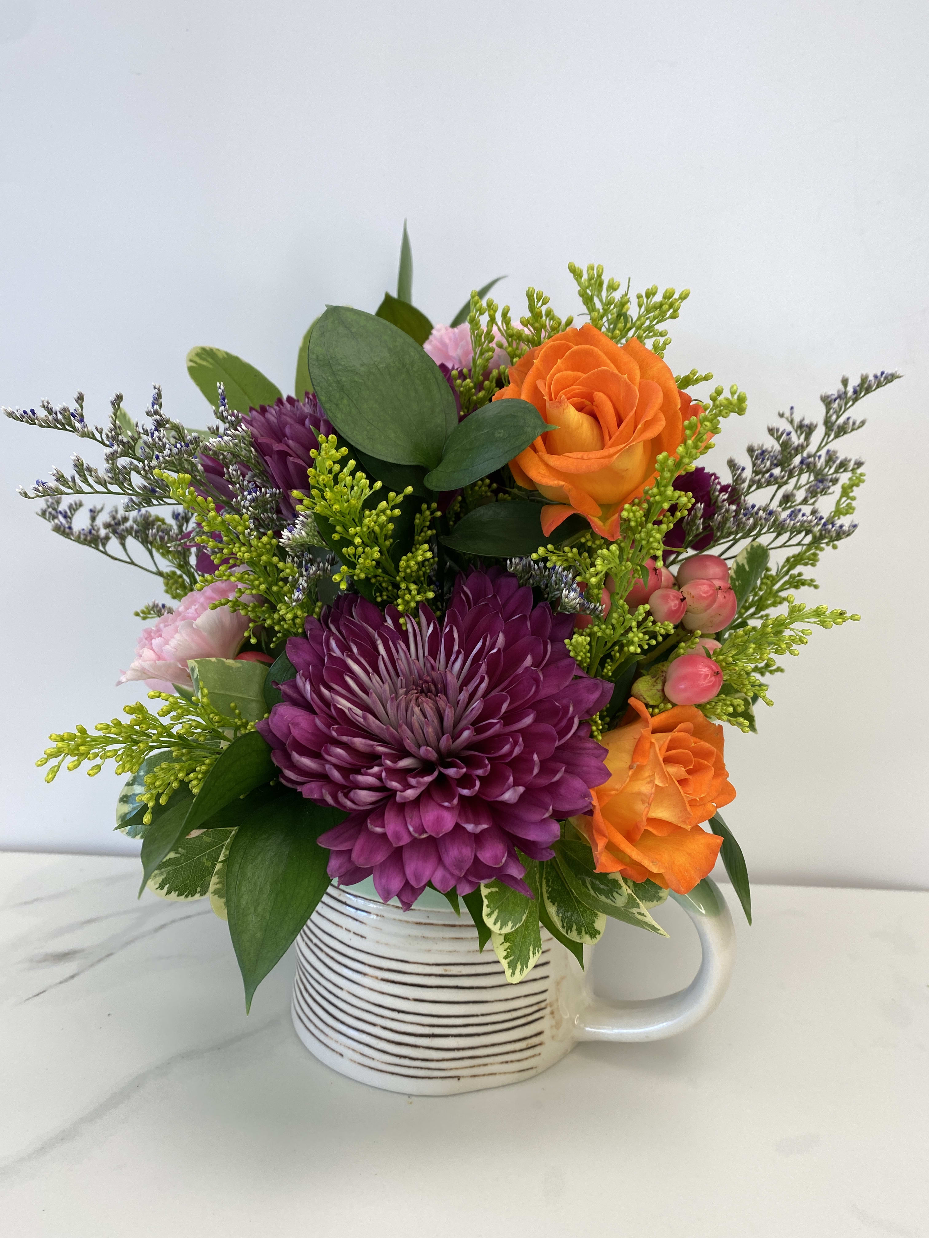 Mug in Bloom. An arrangement by Flower Trends Florists.