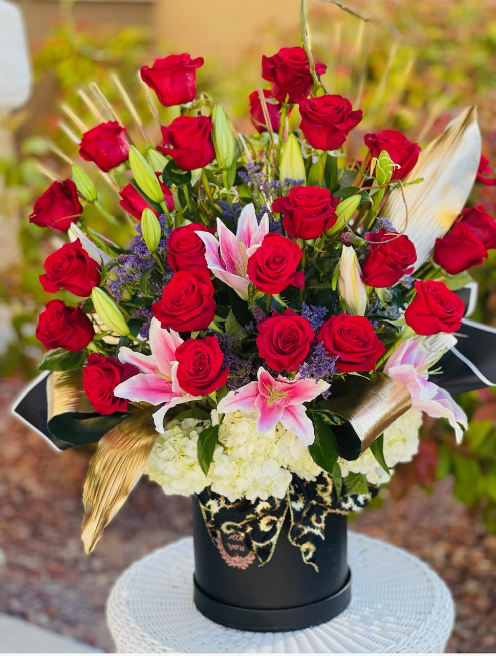 Roses and lilies in the box. An arrangement by Floral Lady Design Studio LLC.