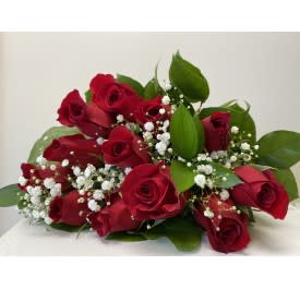 Red Roses Wrapped. An arrangement by Flower Trends Florists.