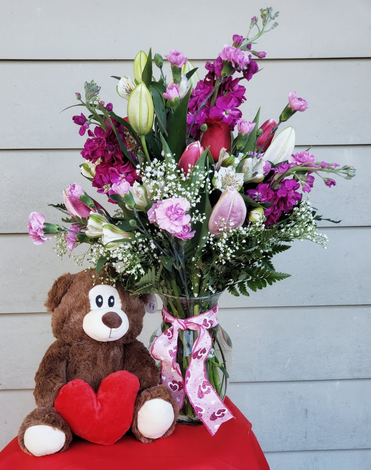 Valentine's Day Special with Teddy Bear. An arrangement by Cupid's Petals.