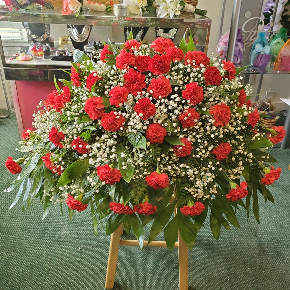 Fresh Red Carnation Casket Spray. An arrangement by Ebony's Flowers and Gifts.