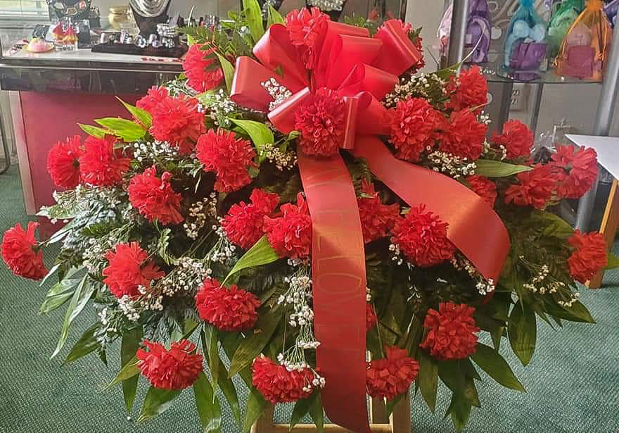 Red Silk Carnation Casket Spray. An arrangement by Ebony's Flowers and Gifts.
