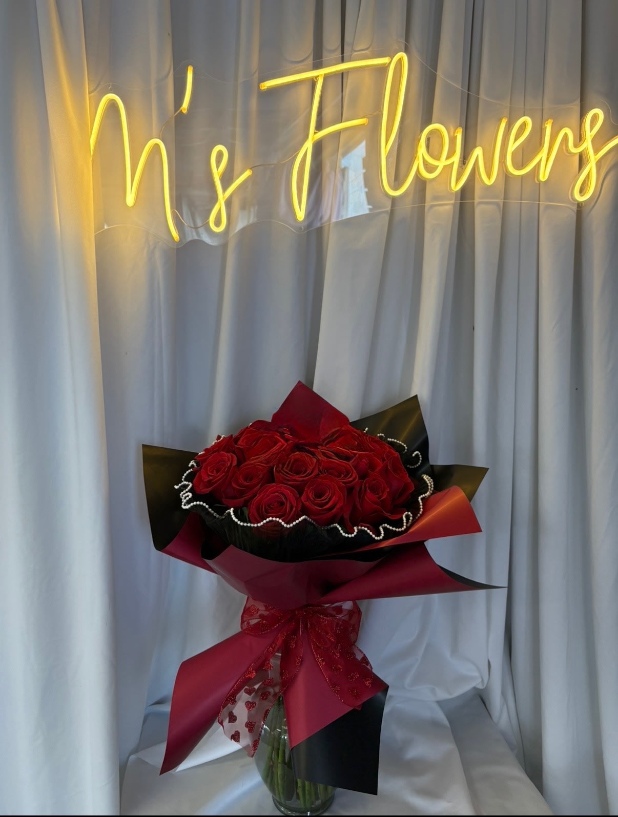 RED ROSE CLUTCH BOUQUET. An arrangement by M's Flowers.