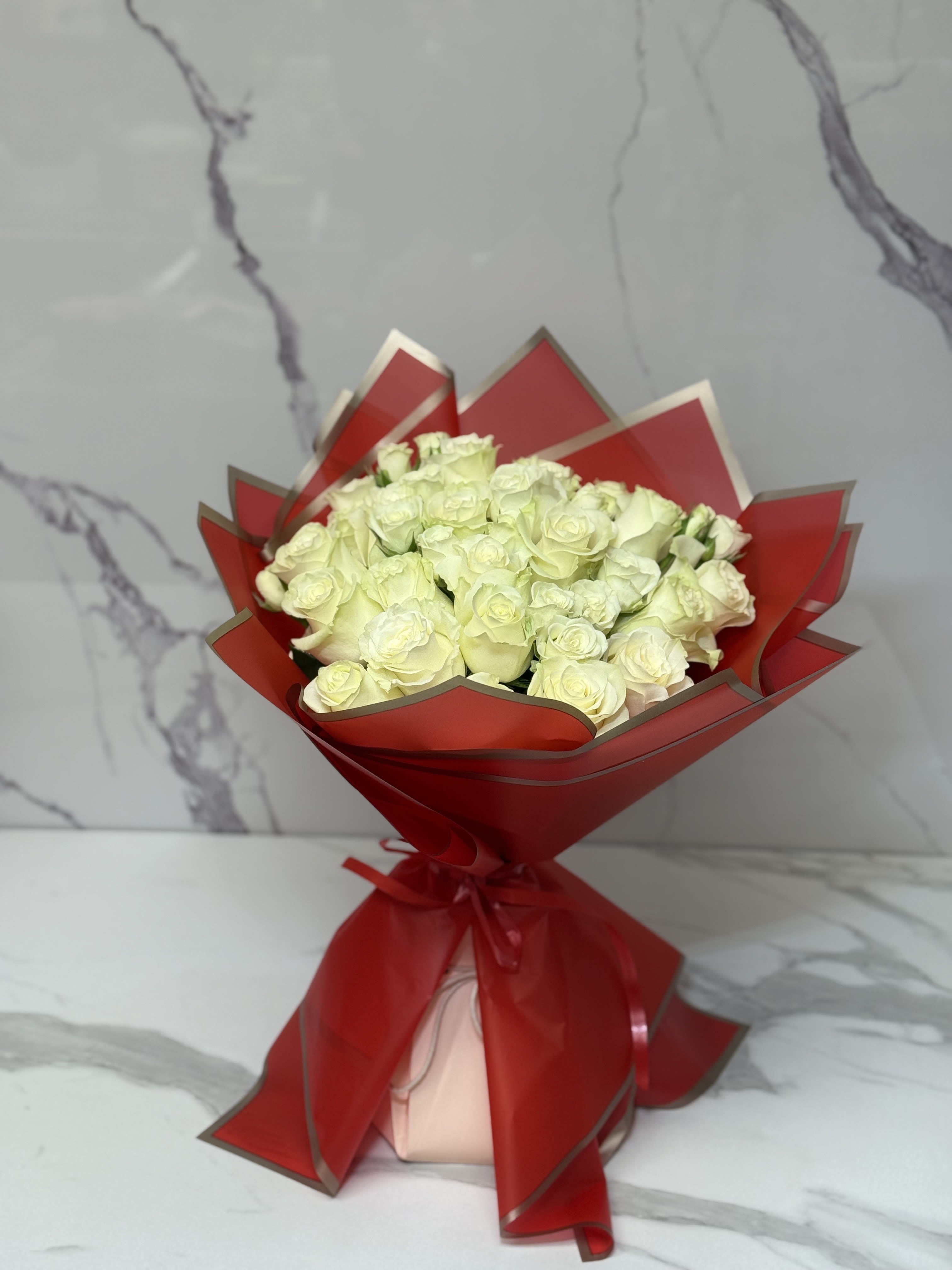 Two Dozen Premium White Roses. An arrangement by Grower's Flower Market and Gifts.