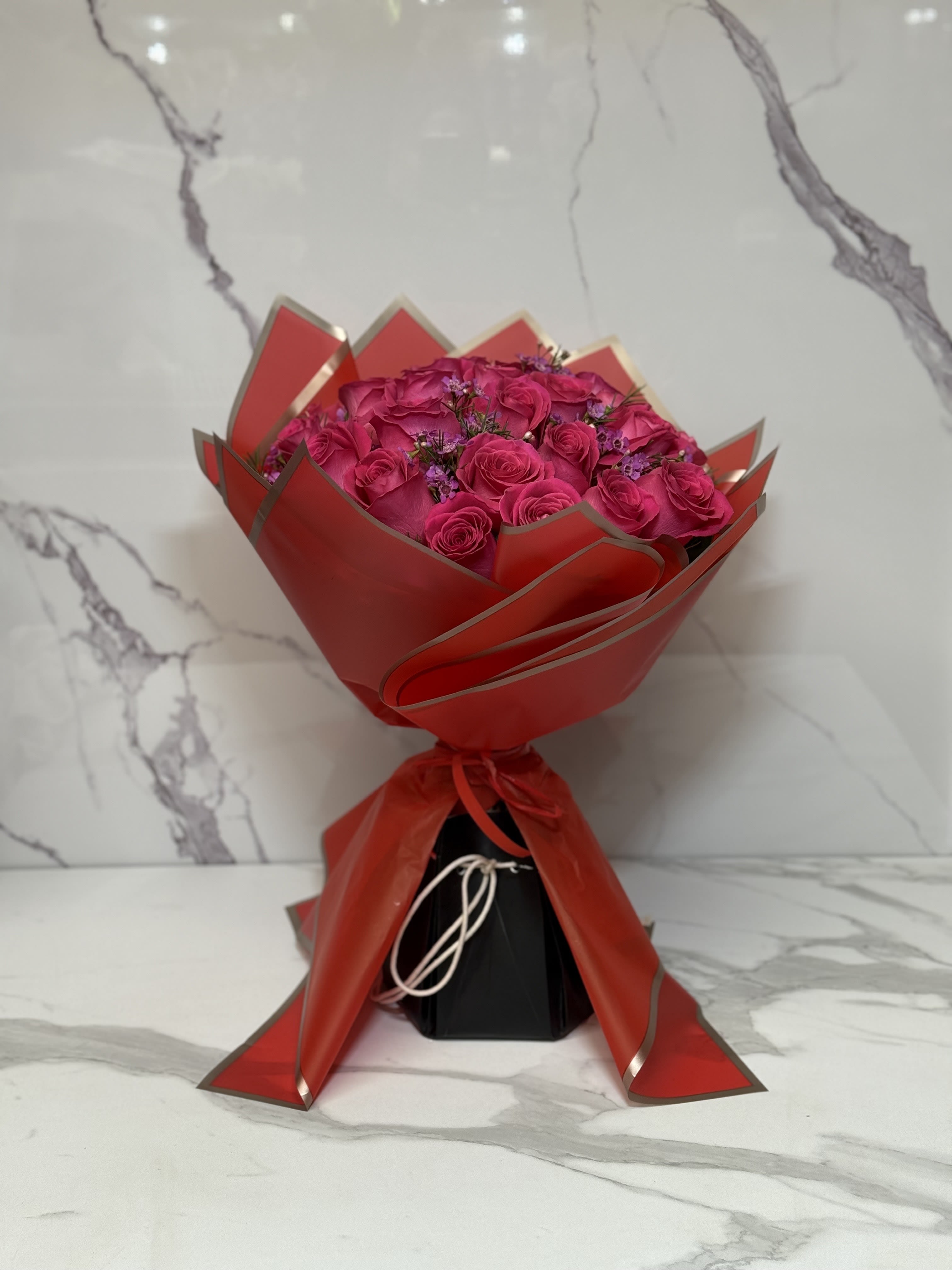 Two Dozen Premium Hot Pink Roses. An arrangement by Grower's Flower Market and Gifts.