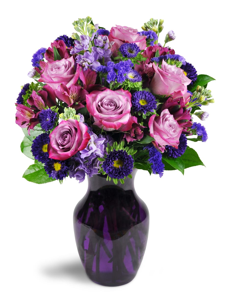 Lovely Lavender™. An arrangement by Avenida Flowers. Sweet lavender roses are cheerfully displayed with alstroemeria, asters, stock, and more in a...