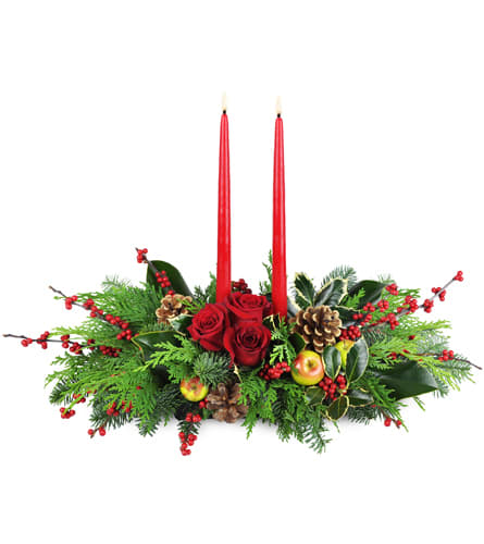 Holiday Floral Feast™. An arrangement by Just Roses Flowers and More. Red roses are nestled between two red taper candles in a large spray of...