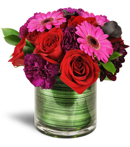 Raspberry Bliss™. An arrangement by Grower Direct. Mini Gerbera daisies, carnations, mini calla lilies, and red roses are stylishly arranged in a...