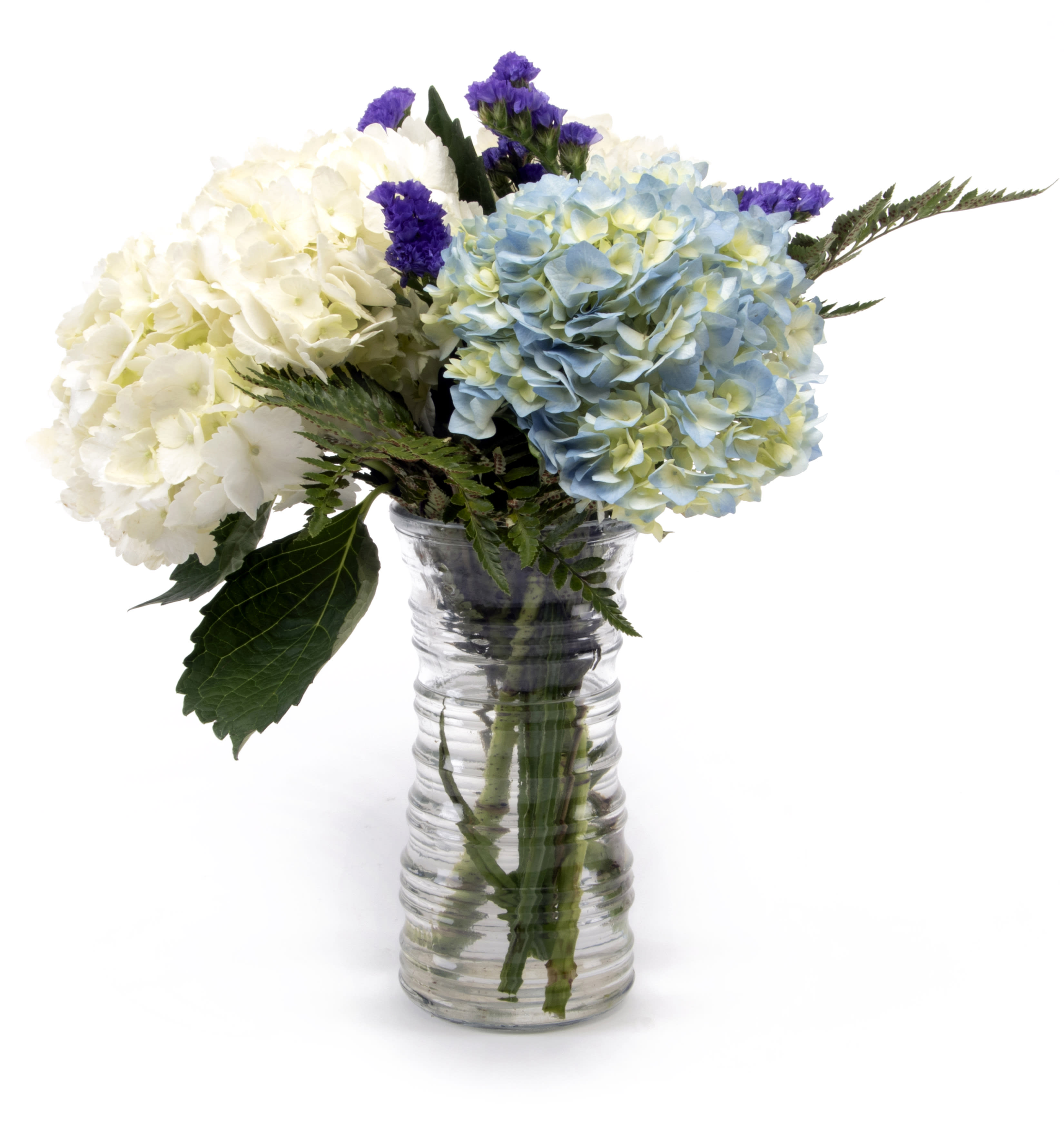 Holy Hydrangeas!. An arrangement by Foxchase Florist. White and blue hydrangeas are mixed with purple status and timelessly arranged in a clear...