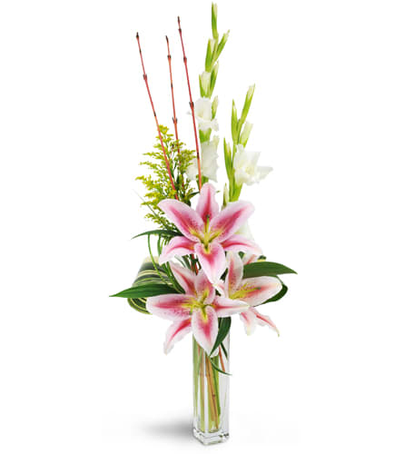 Starry Romance™. An arrangement by Rain Drops and Roses. Oriental lilies, gladiolus, solidago, lush tropical leaves, and more are arranged in a...