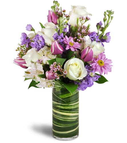 Smiling Grace™. An arrangement by A Touch of Class Flowers and Drapery. Treat them to a graceful bouquet of roses, alstroemeria, tulips, stock,...