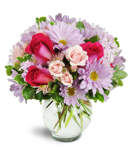 Sweet Surprise™. An arrangement by Violeta's Flower Shop. Hot pink roses stand out among light pink and lavender daisies, spray roses, and more..