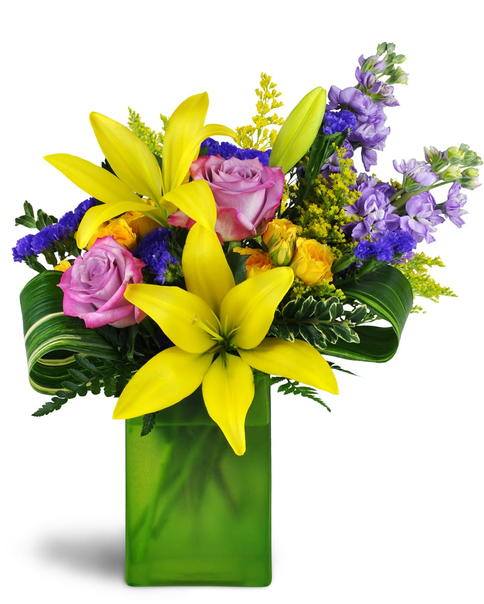 Springtime Kiss™. An arrangement by Pat's Floral Arrangements and Deliveries. Treat them to lavender roses, sunny yellow lilies, purple stock, and...