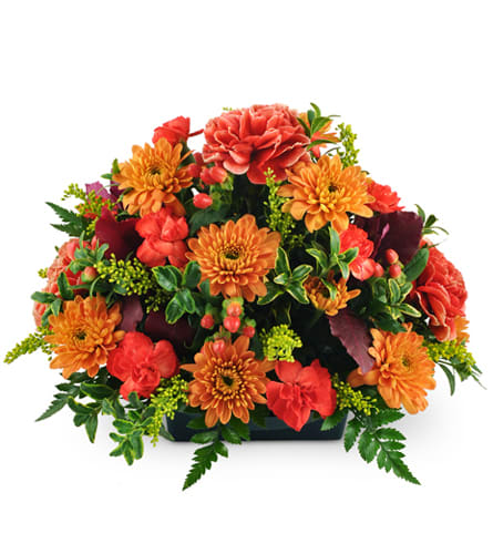 Heart of the Home Centerpiece™. An arrangement by Passiflora Creations LLC. Carnations, mini carnations, and chrysanthemums are arranged with...