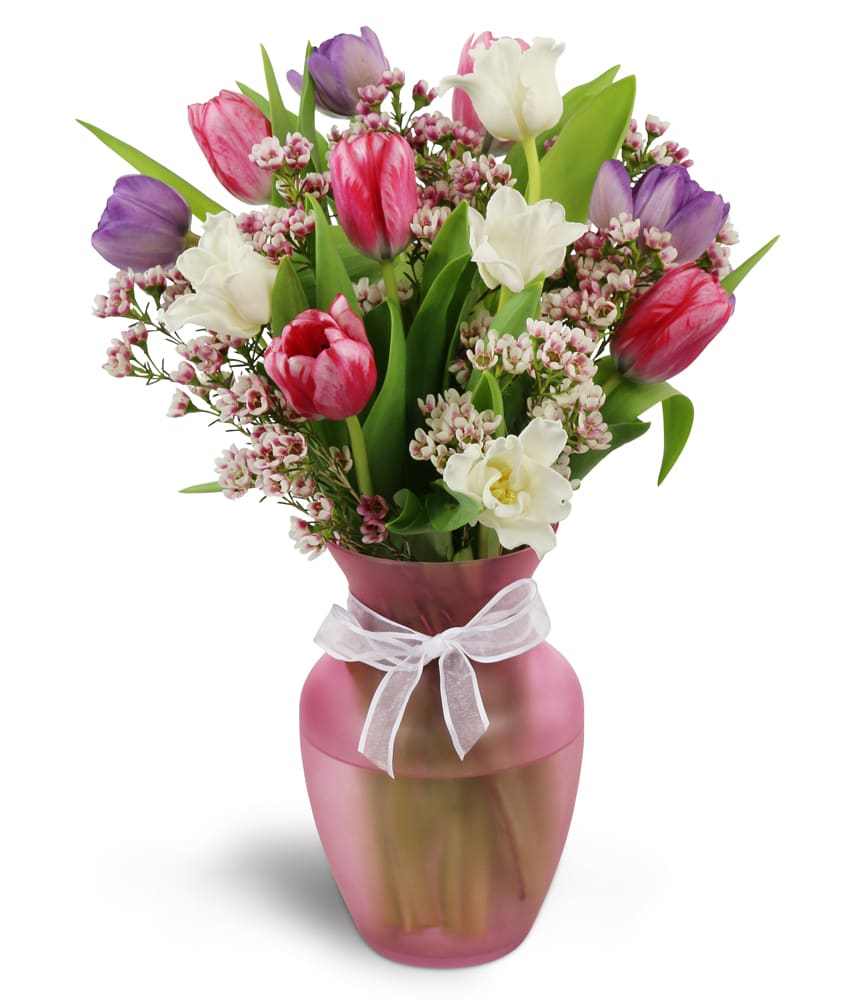 Home Sweet Spring™. An arrangement by Nana's Flower Shop and Gifts. Colorful tulips and waxflower are arranged in a pretty glass vase..