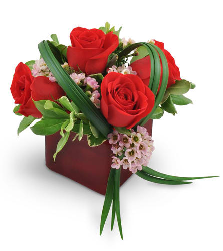He Loves Me. An arrangement by Huffman Floral Inc. Four stunning red roses are artistically arranged with delicate pink waxflower, pittosporum,...