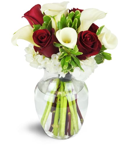 Spoiled Sweet!™. An arrangement by Jodi's Country Corner and Florist. Red roses and white calla lilies are tastefully arranged in a classic rose...