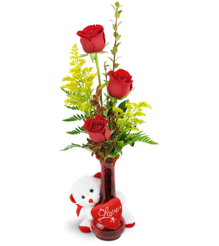 Rose Trio™ with Love Bear. An arrangement by The Flower Shop. Three red roses are arranged with greenery and encircled by a white plush bear..