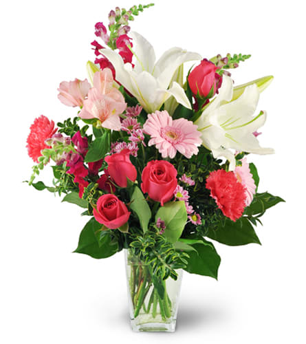 Love Blooms. An arrangement by Hills Valley Floral. White oriental lilies, pink roses, carnations, mini Gerbera daisies, snapdragons,...