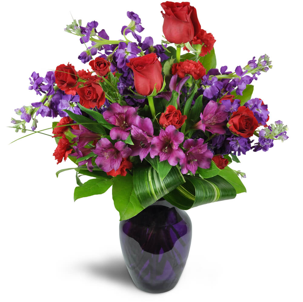Romance Medley™. An arrangement by The Farm and Floral Market. Purple Peruvian lilies are arranged with stunning red spray roses and stock....