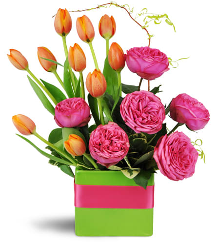 Bright and Breezy™. An arrangement by Jodi's Country Corner and Florist. Vibrant fuchsia garden roses are arranged with festive orange tulips in a...