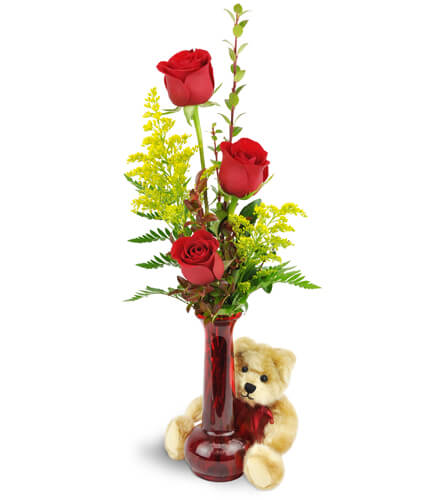 Rose Trio™ with Plush Bear. An arrangement by Cynthia's Flowers and Gifts. Three red roses are arranged with greenery and encircled by a beige...