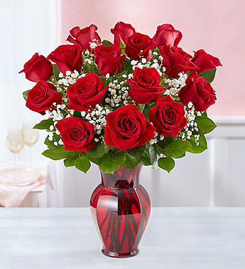 Blooming Love™ Red Roses in Red Vase. An arrangement by Flowers of Jacksonville.
