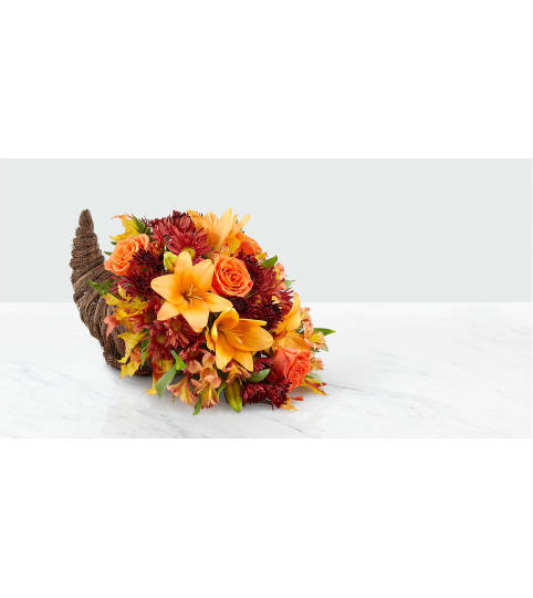 HARVEST GATHERING CORNUCOPIA. An arrangement by J.D. Ballantine's Flowers and Gifts.