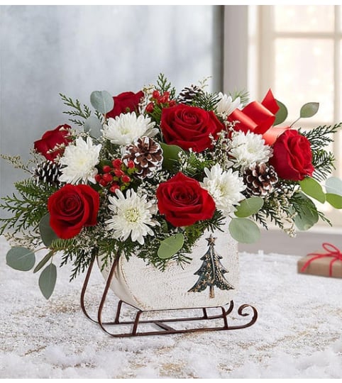 Dashing Through the Snow Sleigh™. An arrangement by Butterflies Flower Shop.