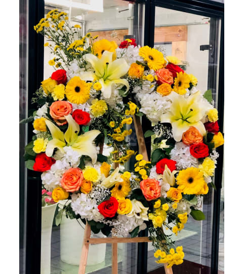 Wreath Beyond the Sun. An arrangement by Geni's Florist and Gifts.